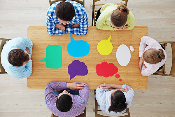 thinking and speech bubbles around people at a table